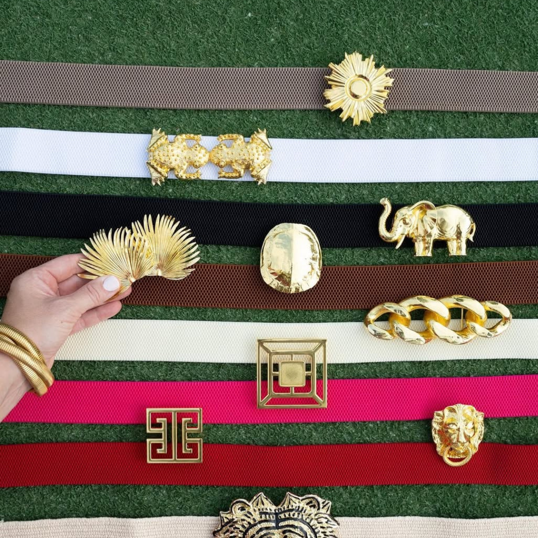 a hand holding a gold object