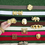 a hand holding a gold object