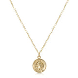 a gold necklace with a coin