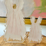 a glass figurines of angels on a table