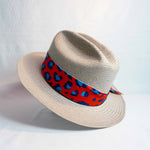 a hat with a red and blue ribbon
