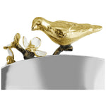 a gold bird on a silver bowl
