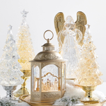 a group of glass trees and a candle holder