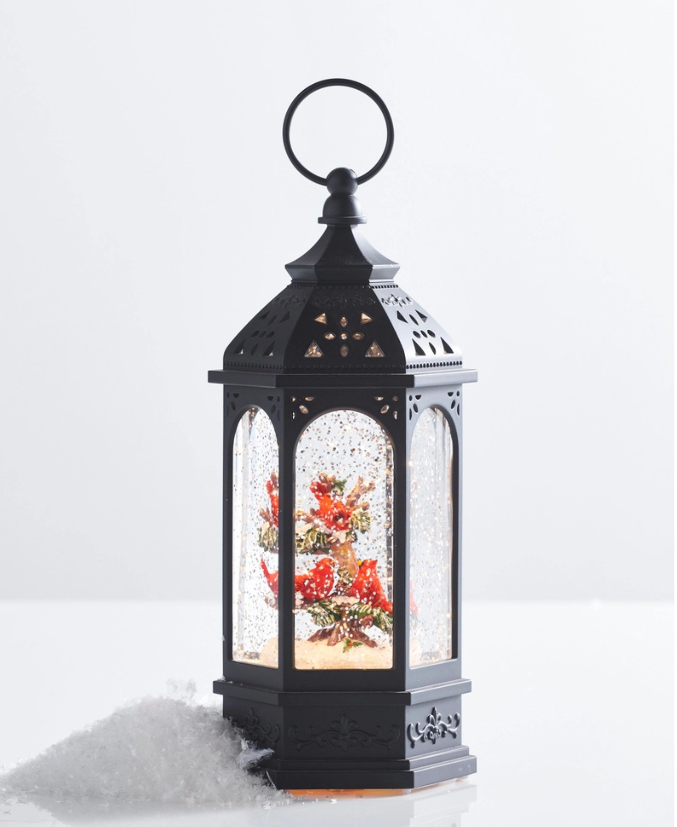 a lantern with a snow globe