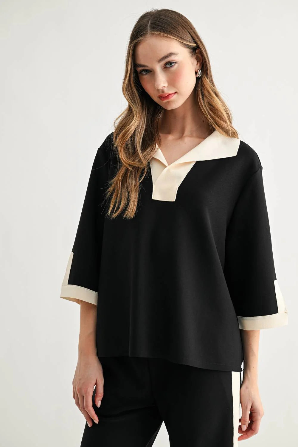 a woman in a black and white shirt