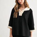 a woman in a black and white shirt