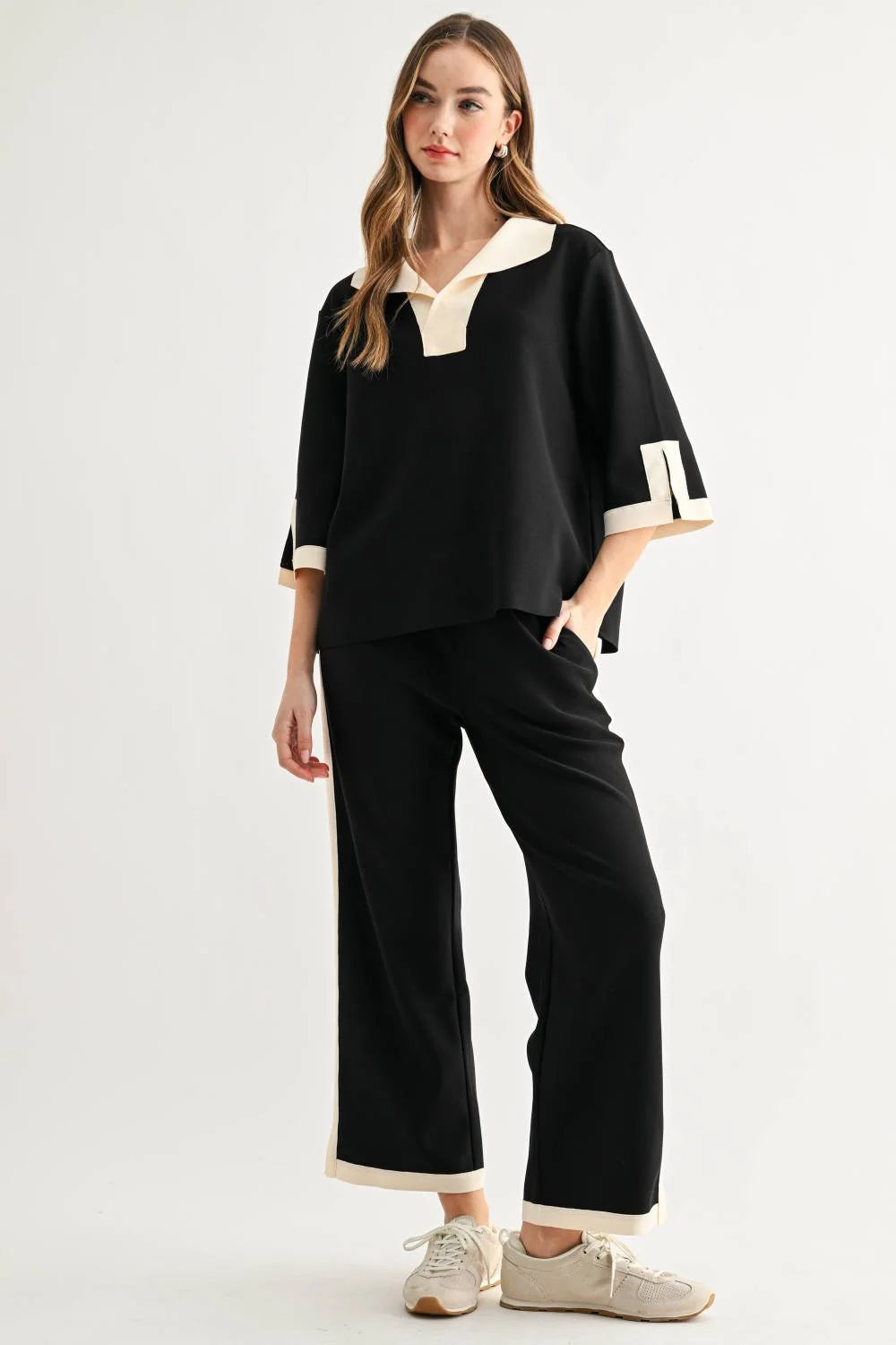 a woman in a black and white outfit