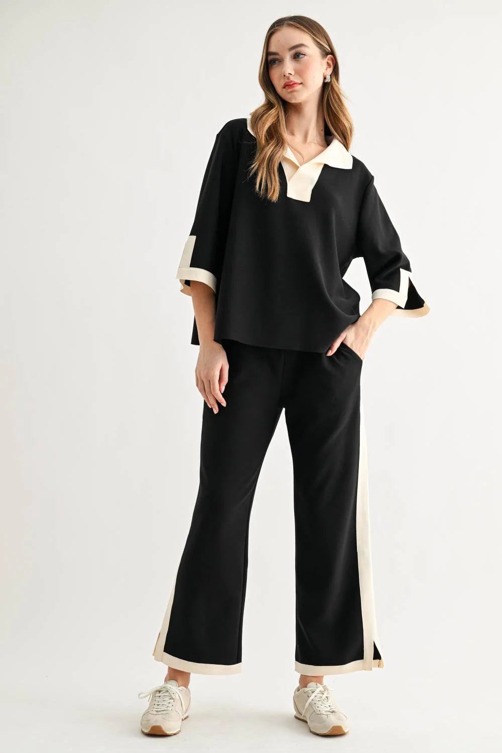 a woman in a black and white outfit