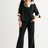 a woman in a black and white outfit