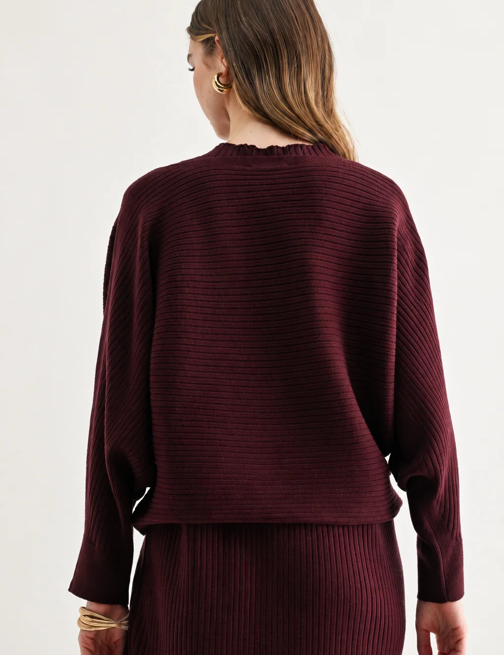 a woman in a maroon sweater