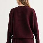 a woman in a maroon sweater