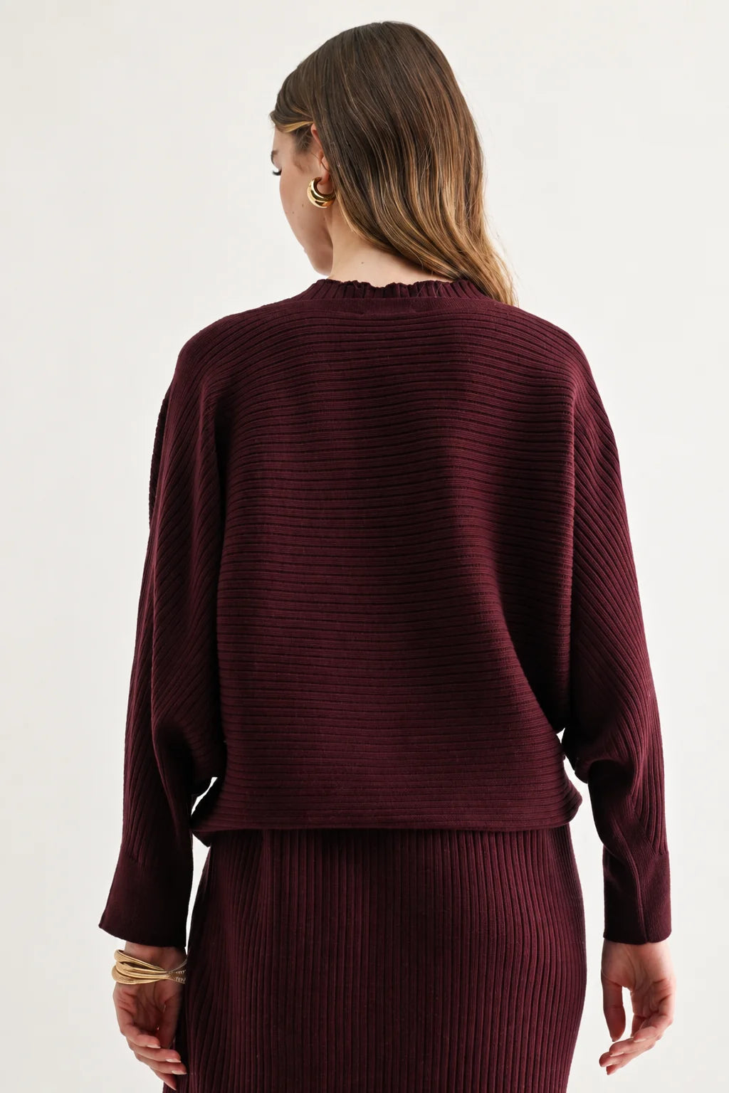 a woman in a maroon sweater