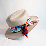 a hat with a red and blue ribbon