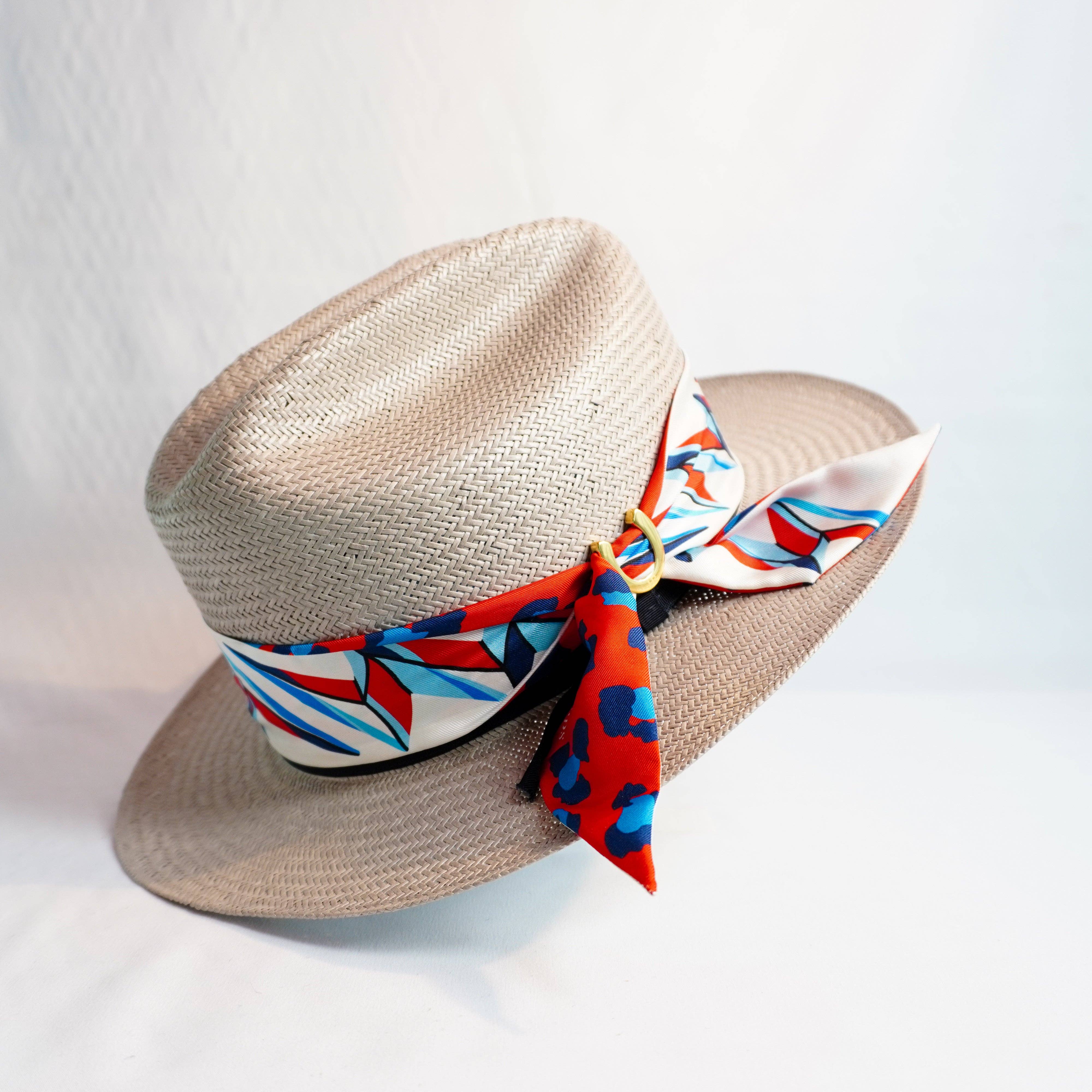 a hat with a red and blue ribbon