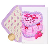 a purple envelope with a picture of a cake and a coin