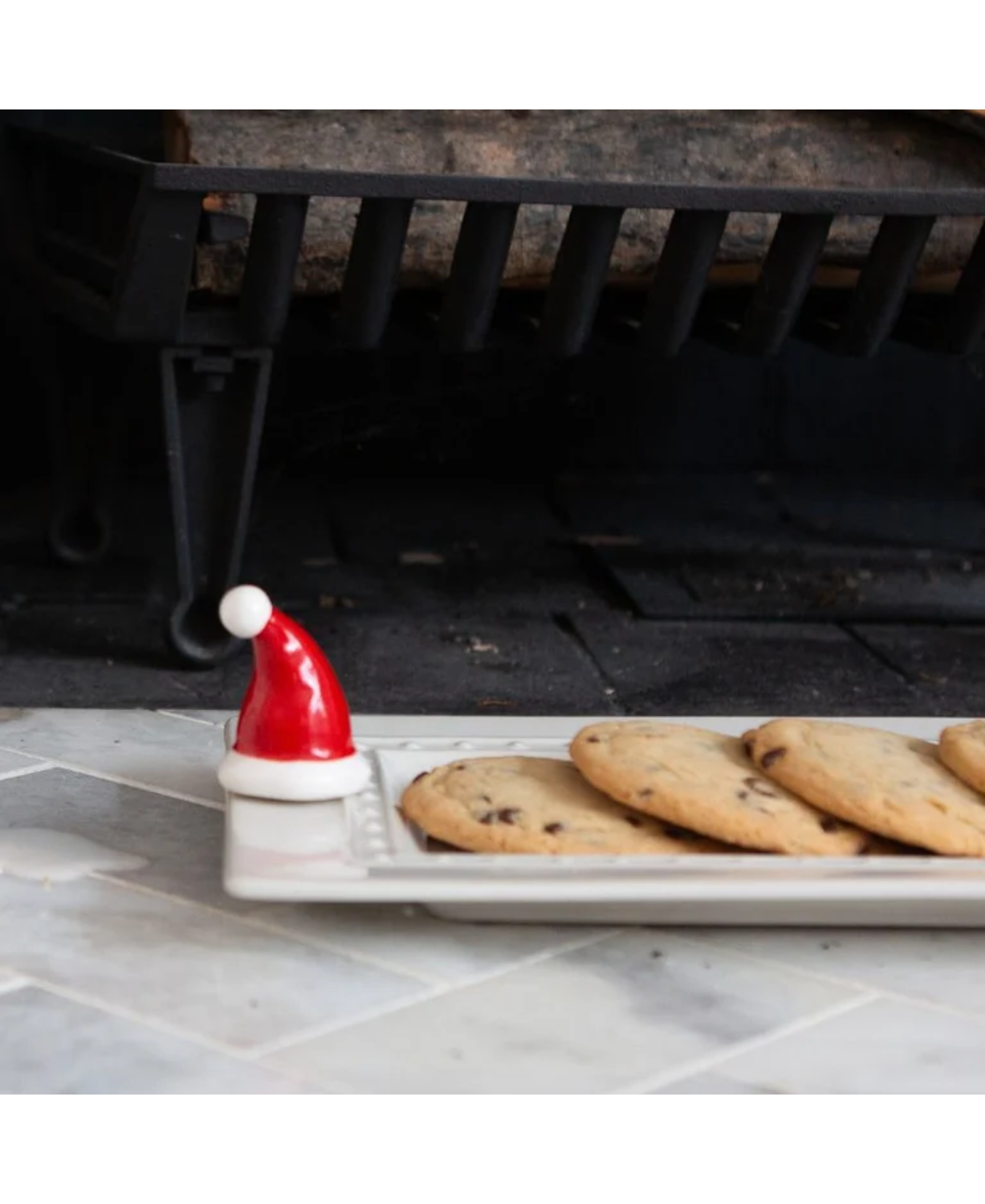 a plate of cookies with a santa hat on it