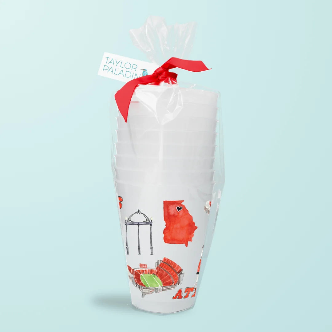 a stack of white cups with red ribbon