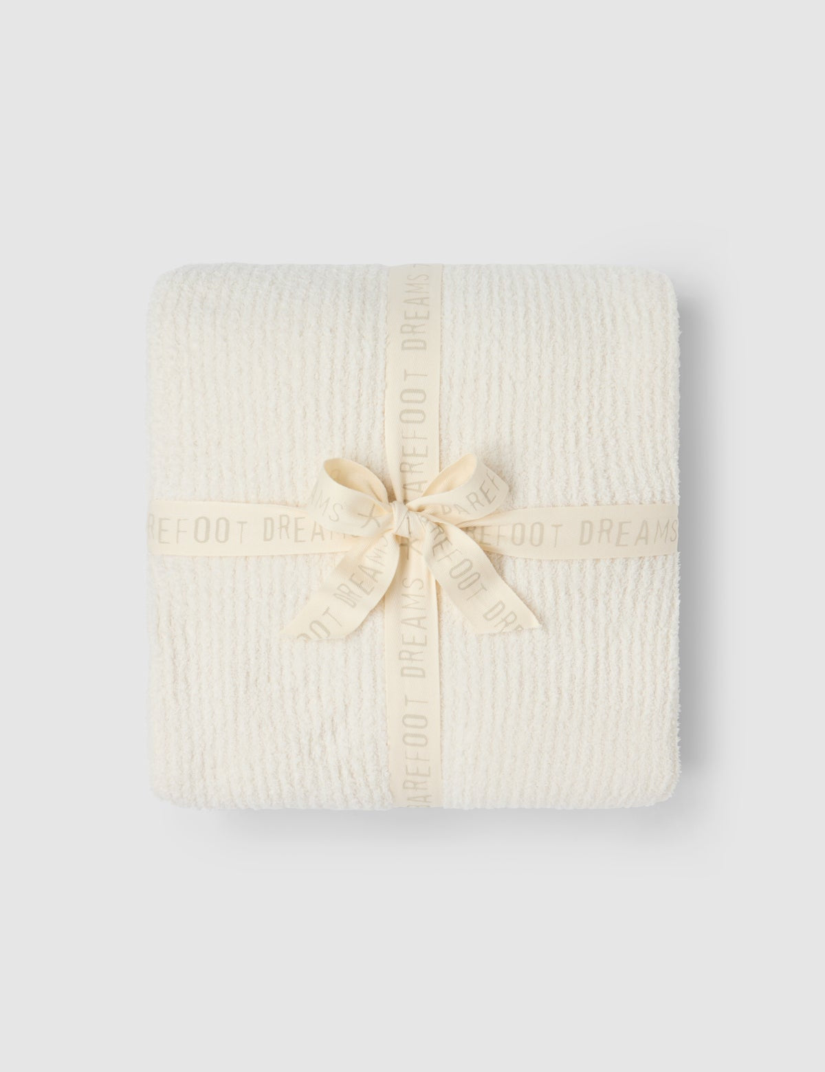 a white blanket wrapped in a ribbon
