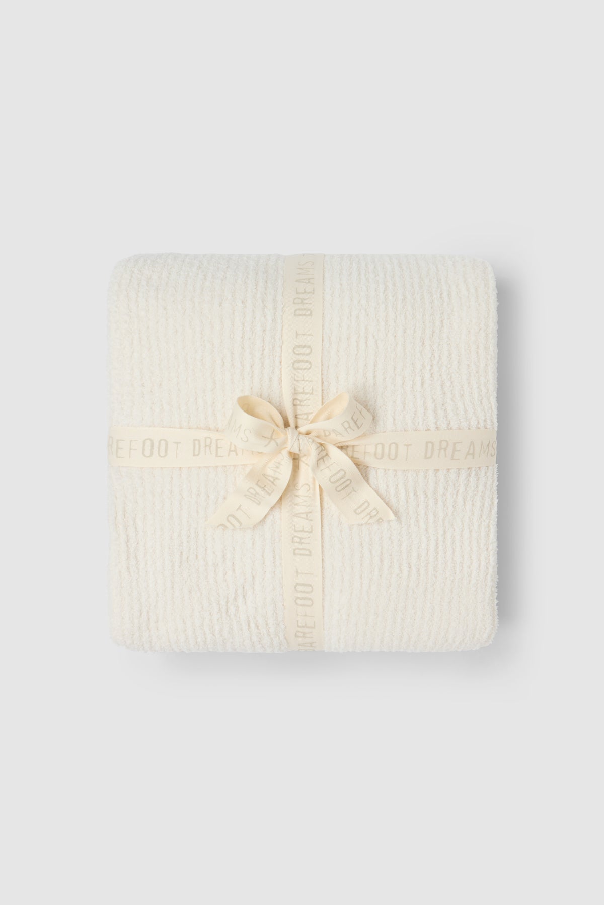 a white blanket wrapped in a ribbon