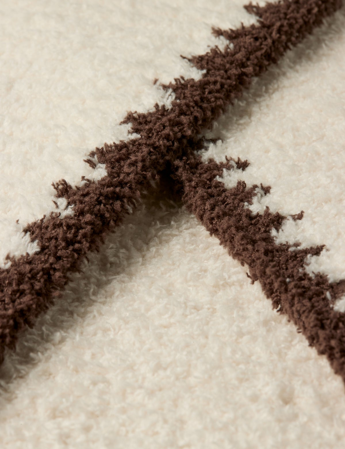 a close up of a white and brown carpet