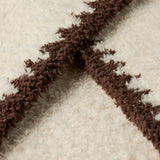 a close up of a white and brown carpet