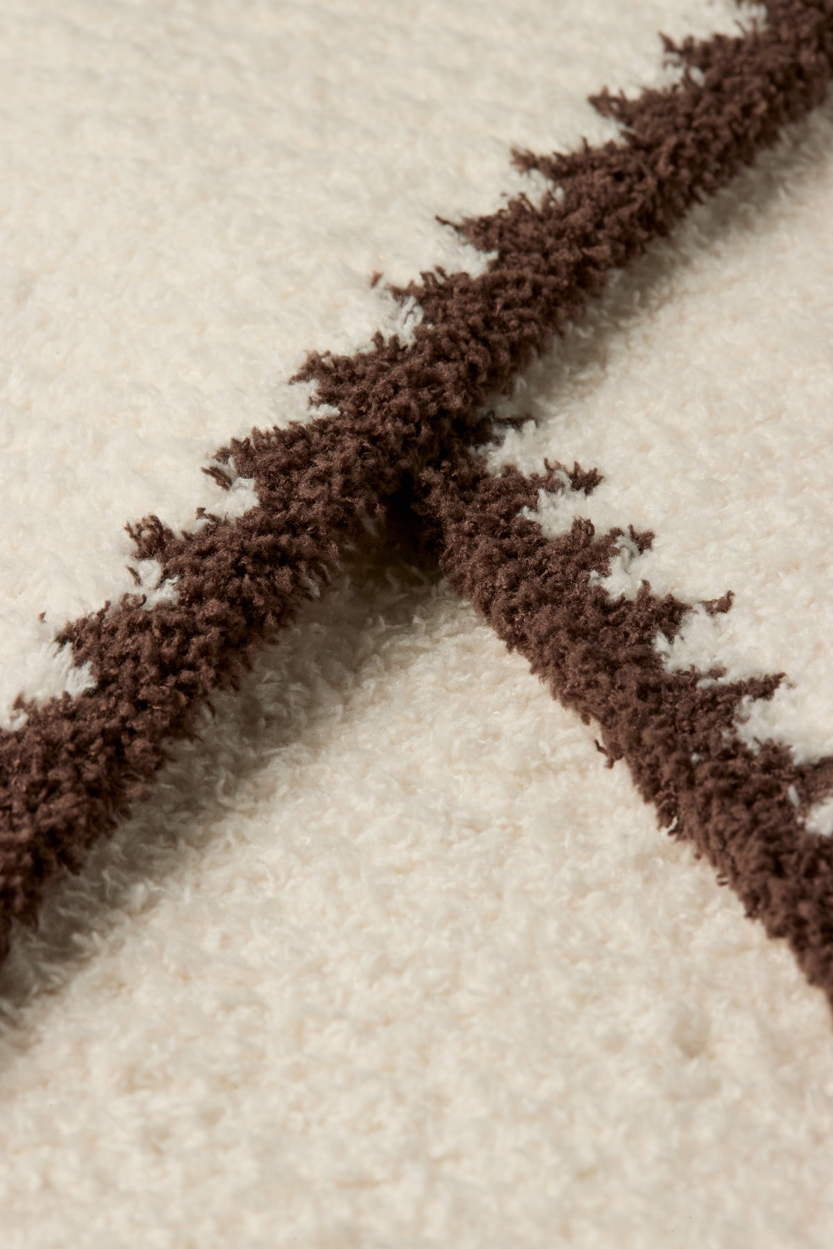 a close up of a white and brown carpet