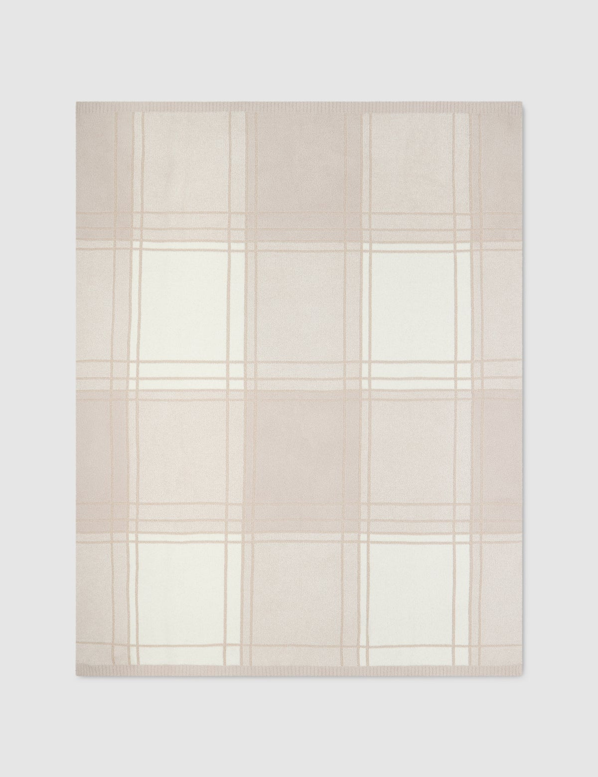 a white and pink plaid blanket