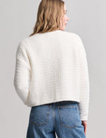 a woman in a white sweater