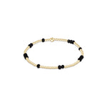 a gold and black beaded bracelet