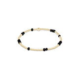 a gold and black beaded bracelet
