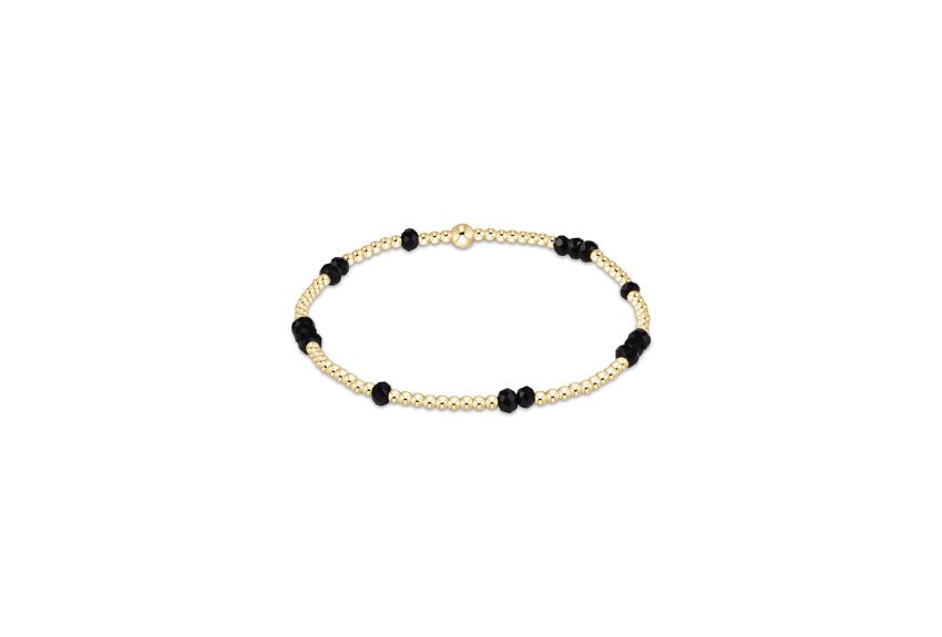 a gold and black beaded bracelet