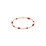 a gold and red beaded bracelet