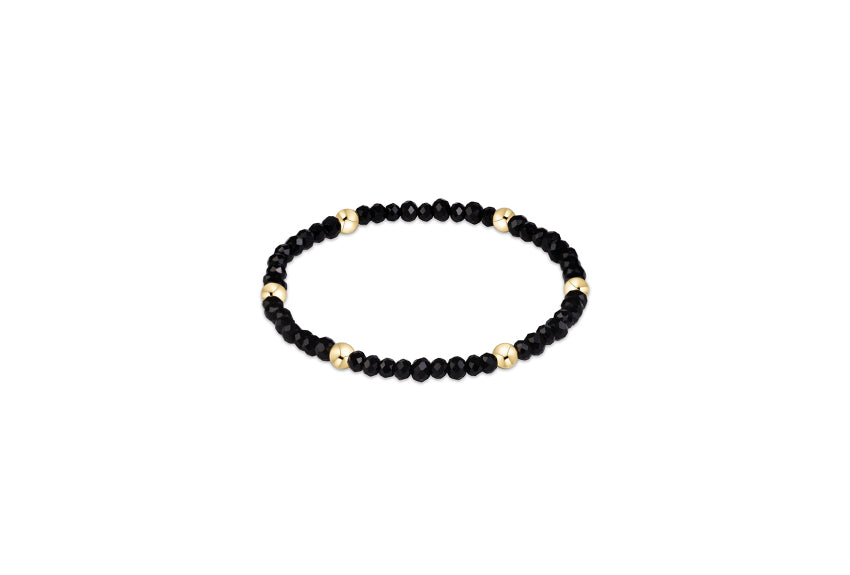 a black and gold beaded bracelet