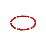 a red and gold beaded bracelet