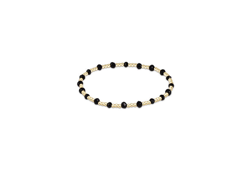 a black and gold beaded bracelet
