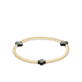 a gold and black beaded bracelet