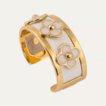 a gold and white bracelet with flowers
