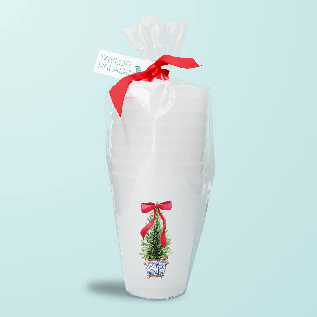 a stack of white cups with a red bow