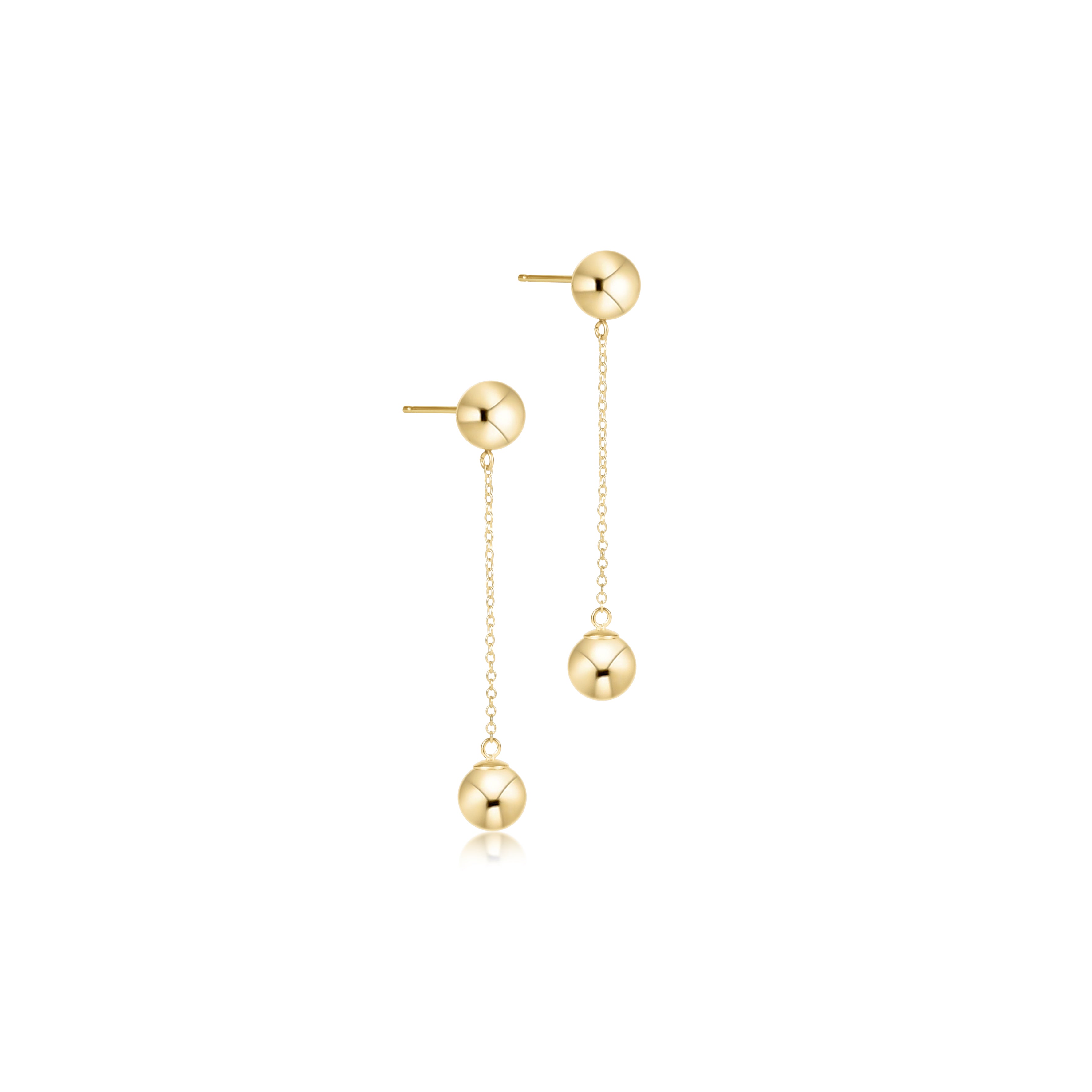 a pair of gold earrings