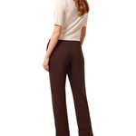 a woman in a white shirt and brown pants