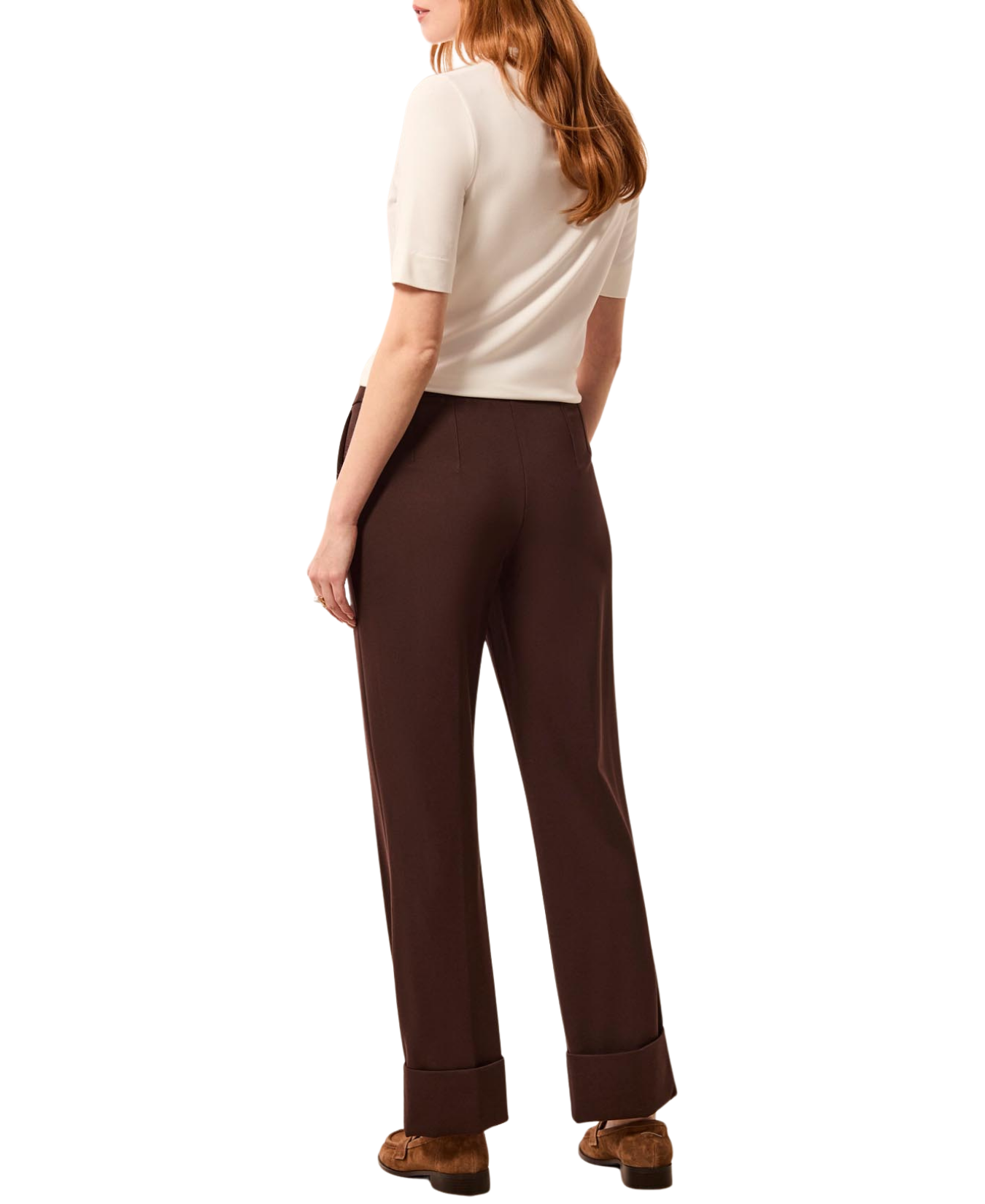 a woman in a white shirt and brown pants