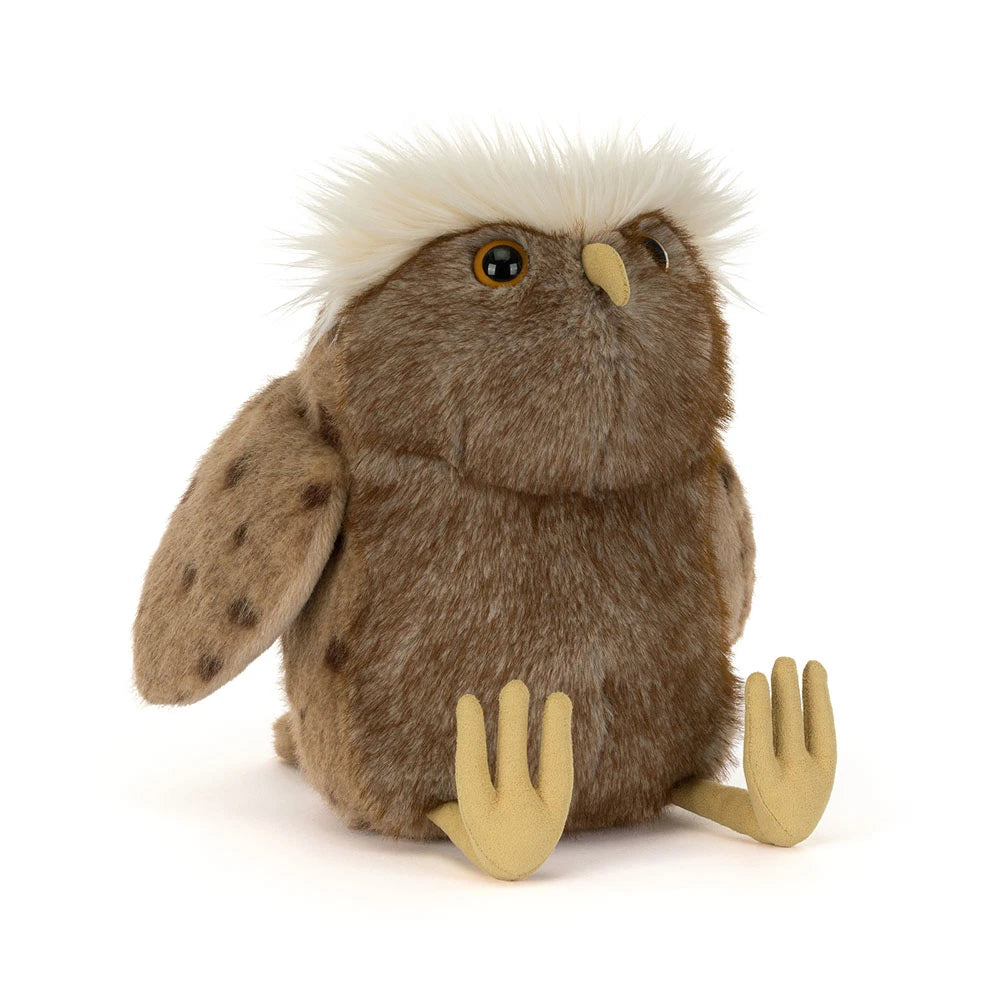 a stuffed animal owl with white hair