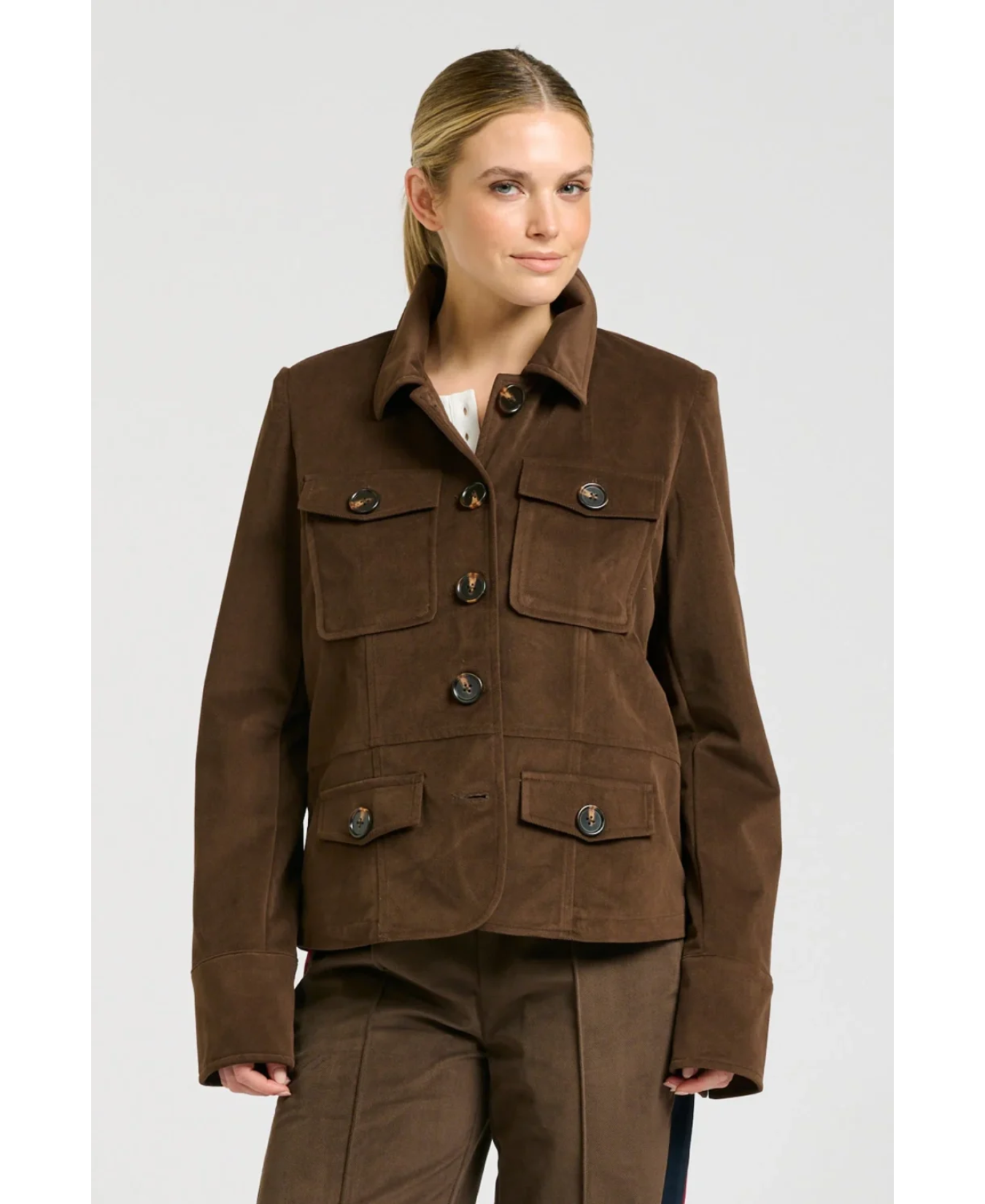 a woman in a brown jacket