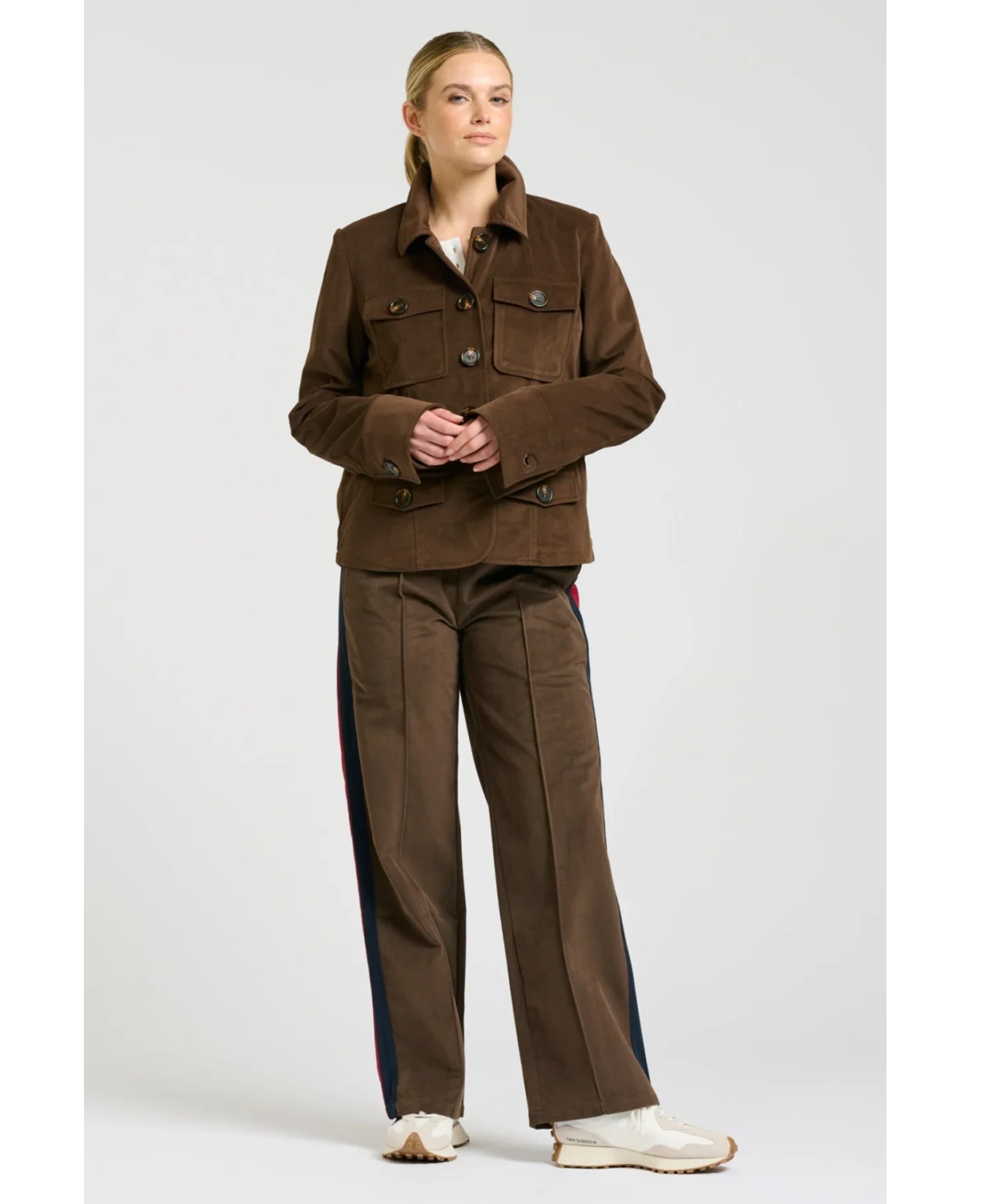 a woman in brown jacket and pants
