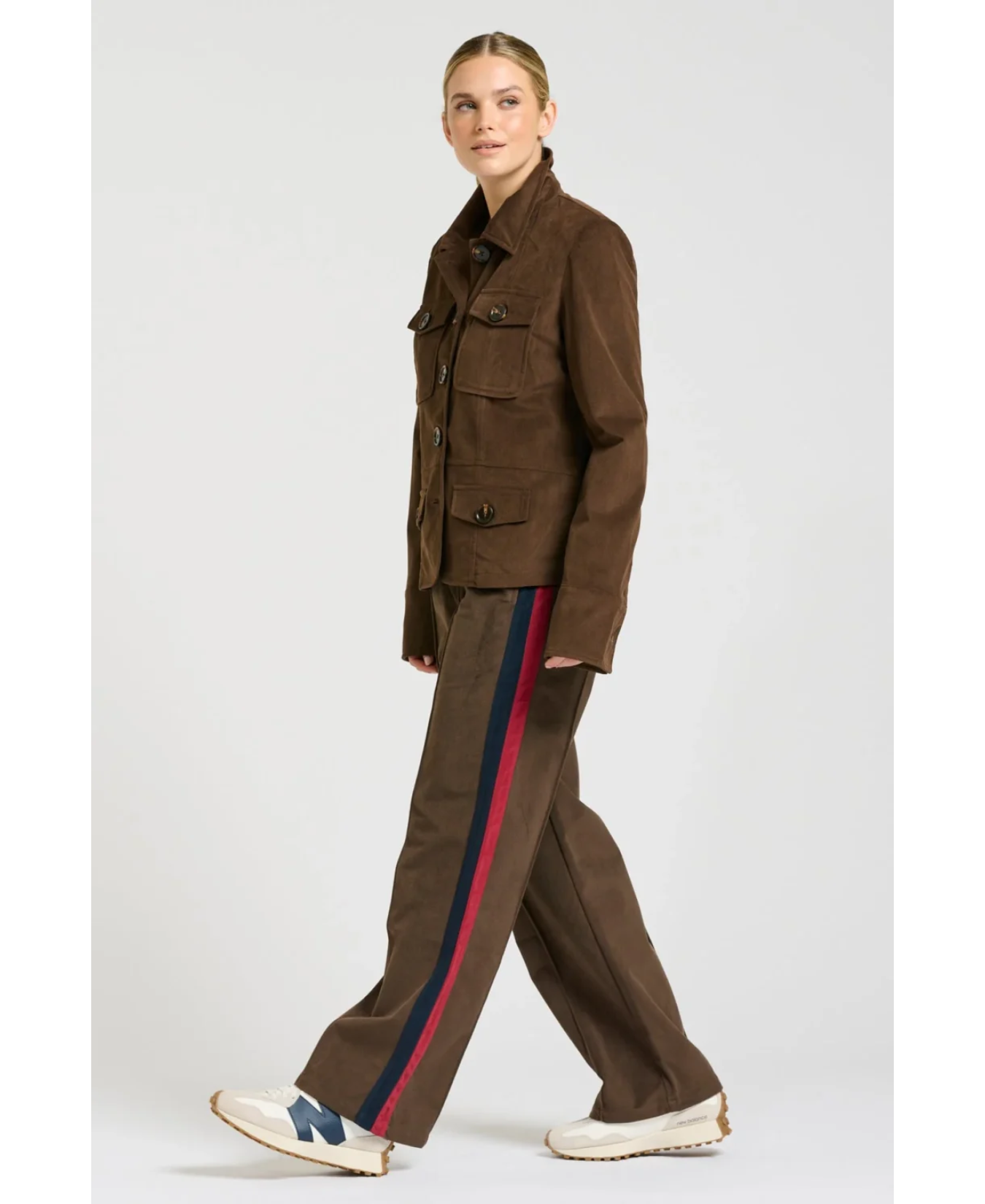 a woman walking in a brown jacket
