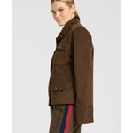 a woman in a brown jacket