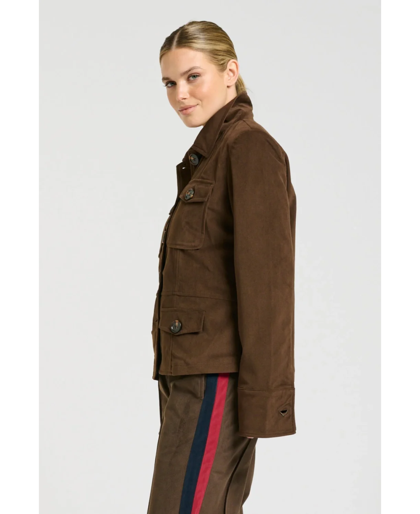 a woman in a brown jacket