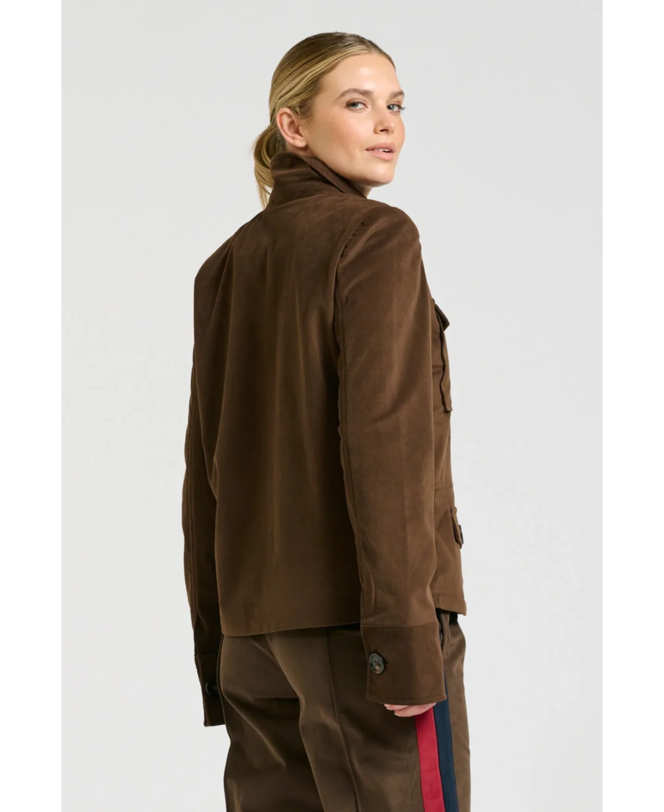 a woman in brown jacket
