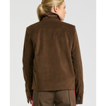 a woman in brown jacket