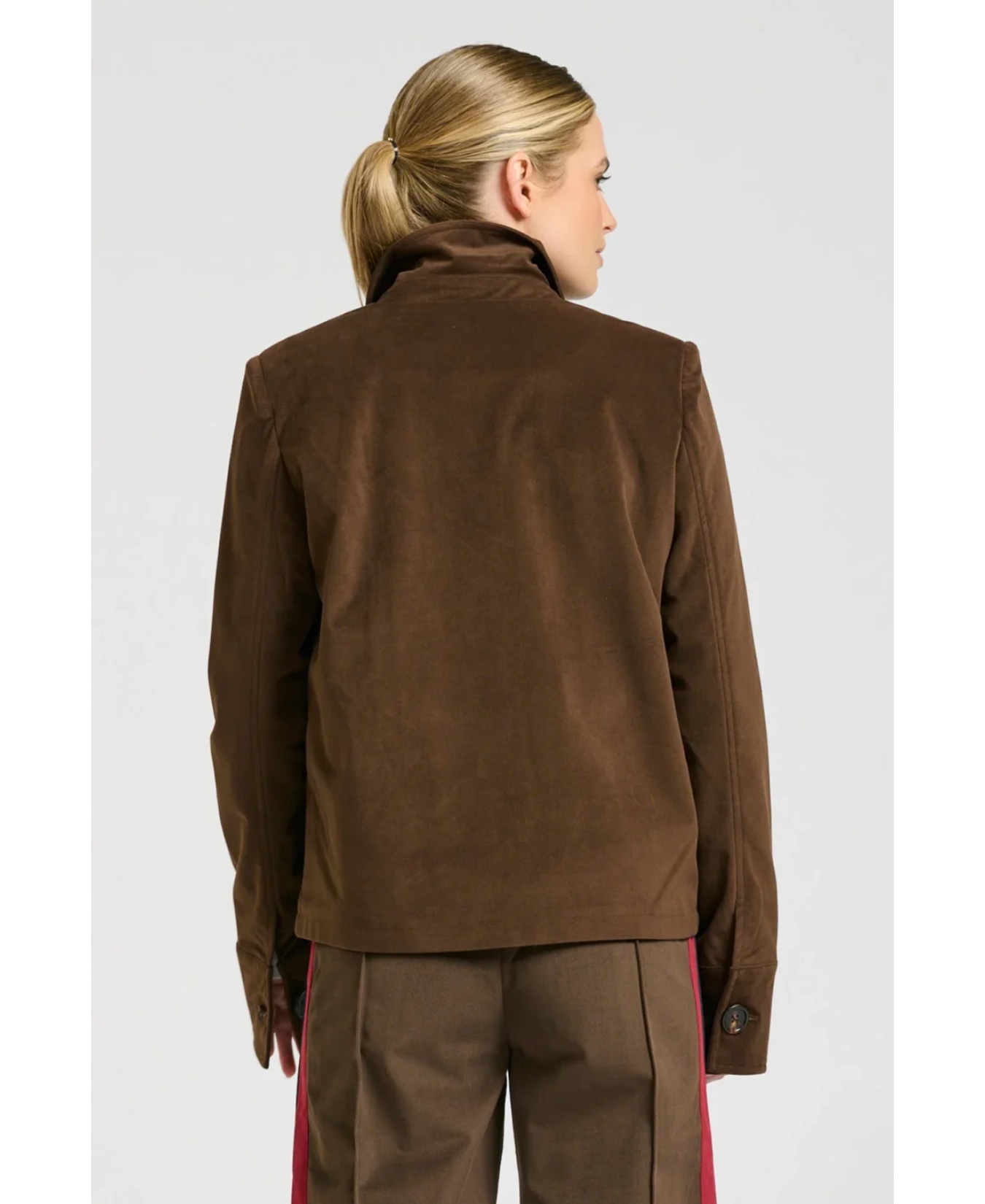 a woman in brown jacket